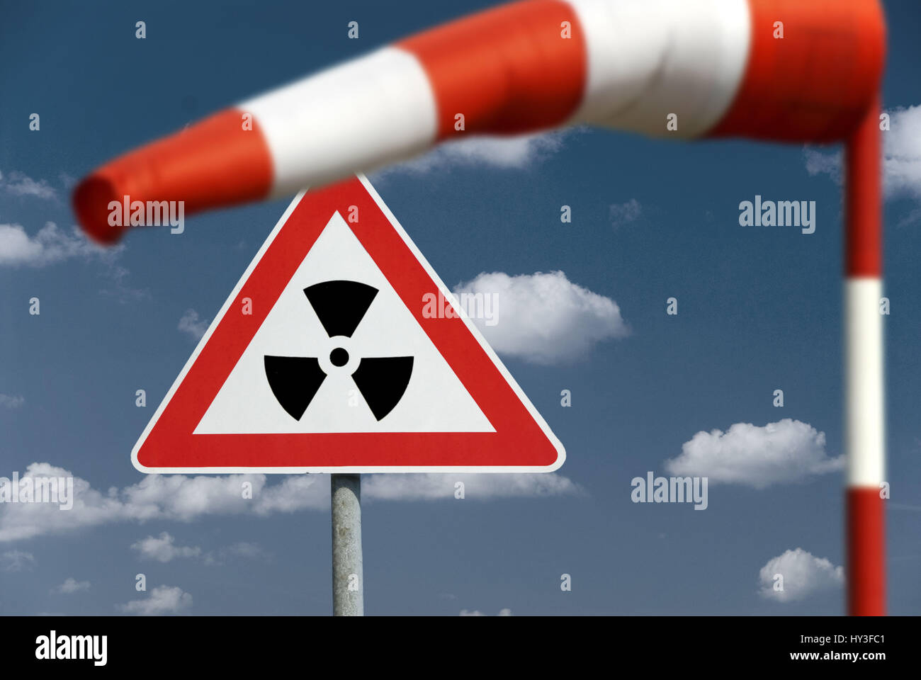 Weathervane and warning radioactivity, radioactive cloud picture assembly, Windfahne und Warnschild Radioaktivität, radioaktive Wolke (Bildmontage) Stock Photo