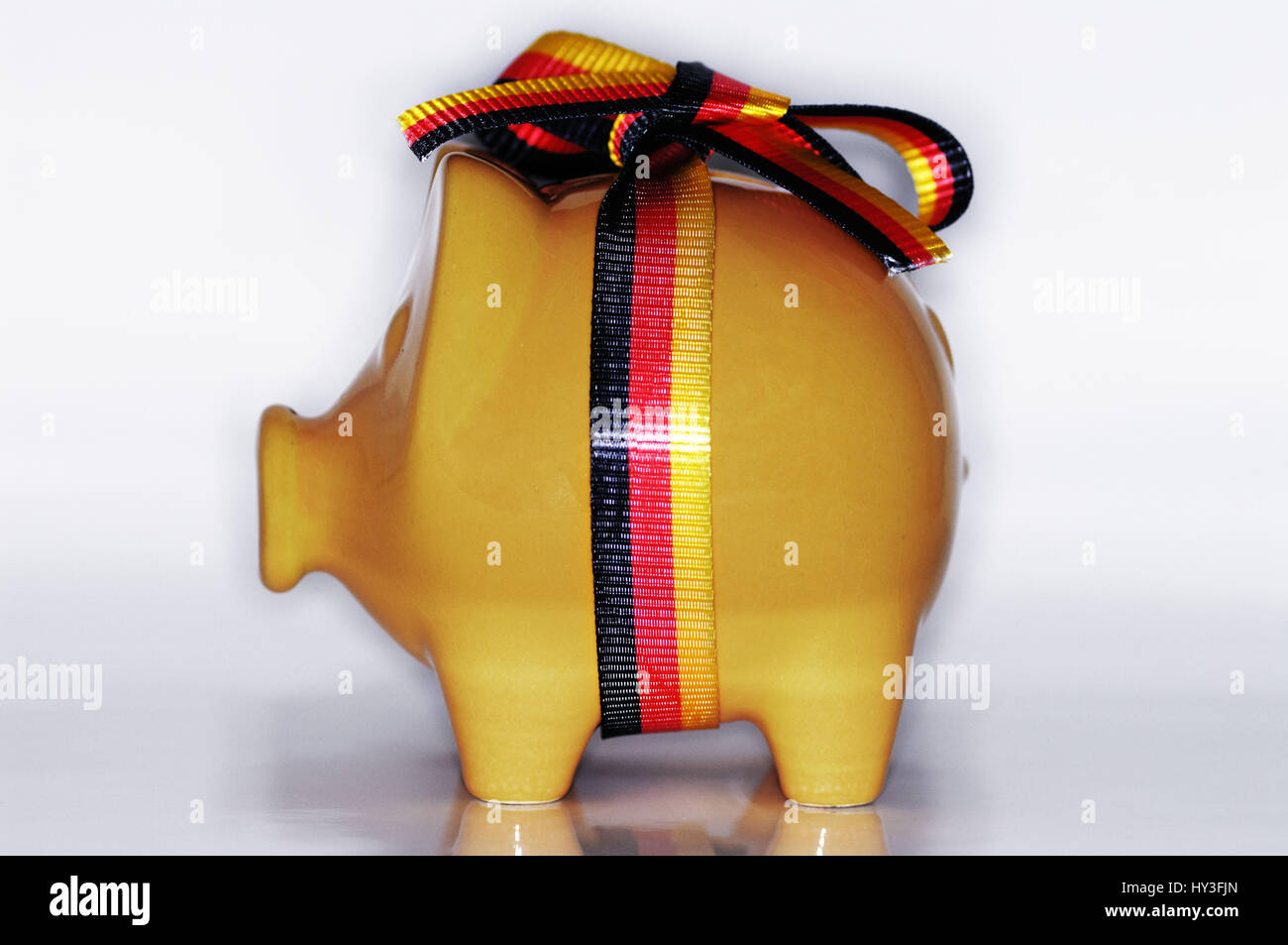 Piggy bank with Germany loop, German savings package, Sparschwein mit Deutschland-Schleife, deutsches Sparpaket Stock Photo