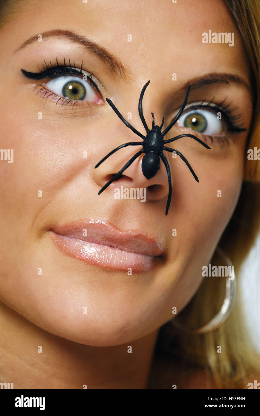 Woman with spider on the nose, spider phobia, Frau mit Spinne auf der Nase, Spinnenphobie Stock Photo