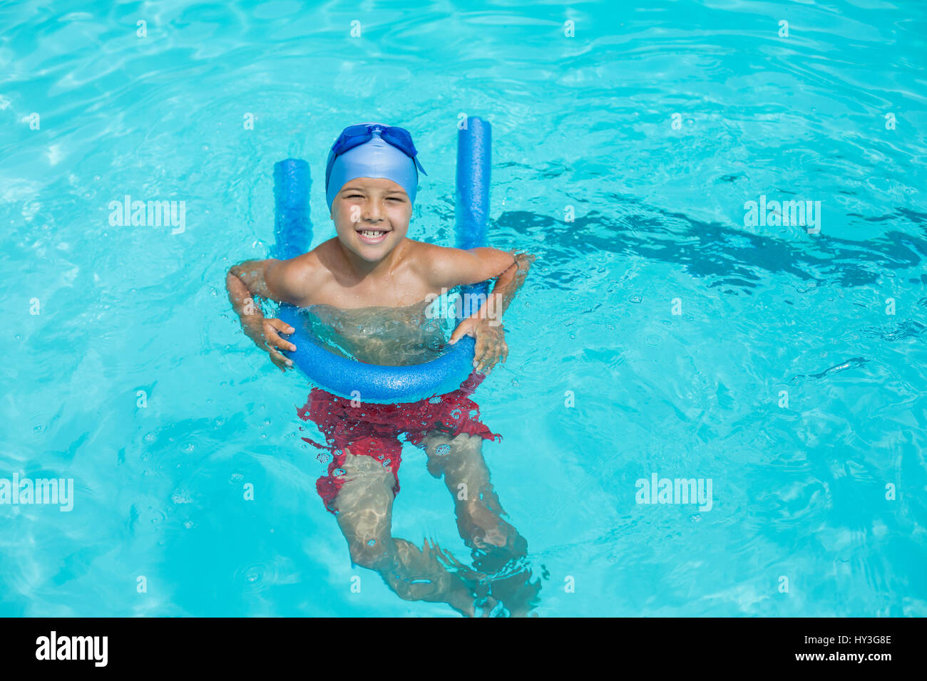 High angle view of boy swimming with pool noodle Stock Photo Alamy