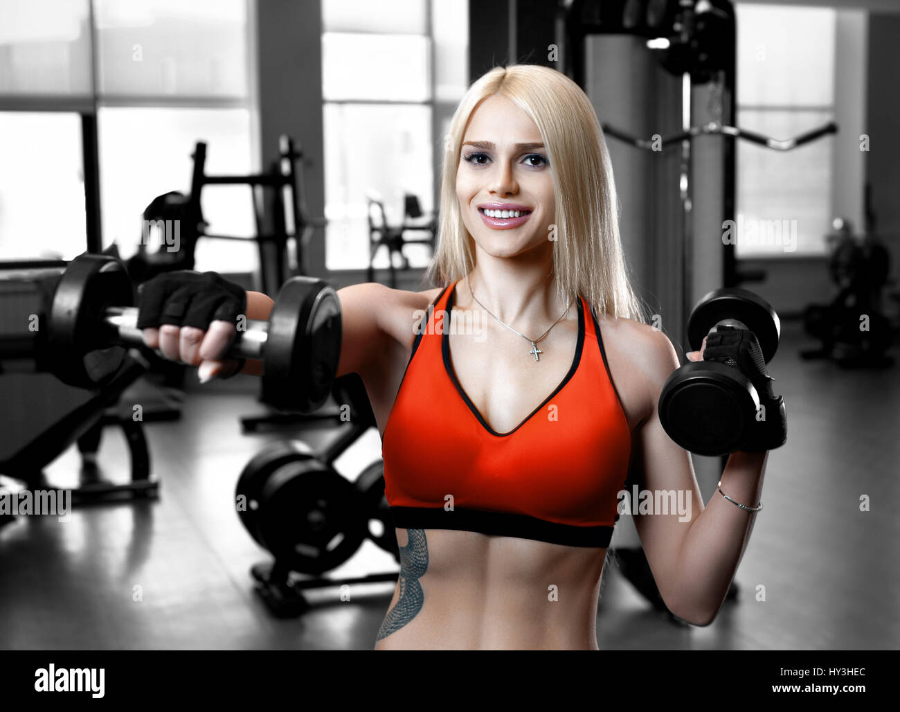 Portrait of a beautiful sexy woman dressed in sports clothes in the gym  Stock Photo