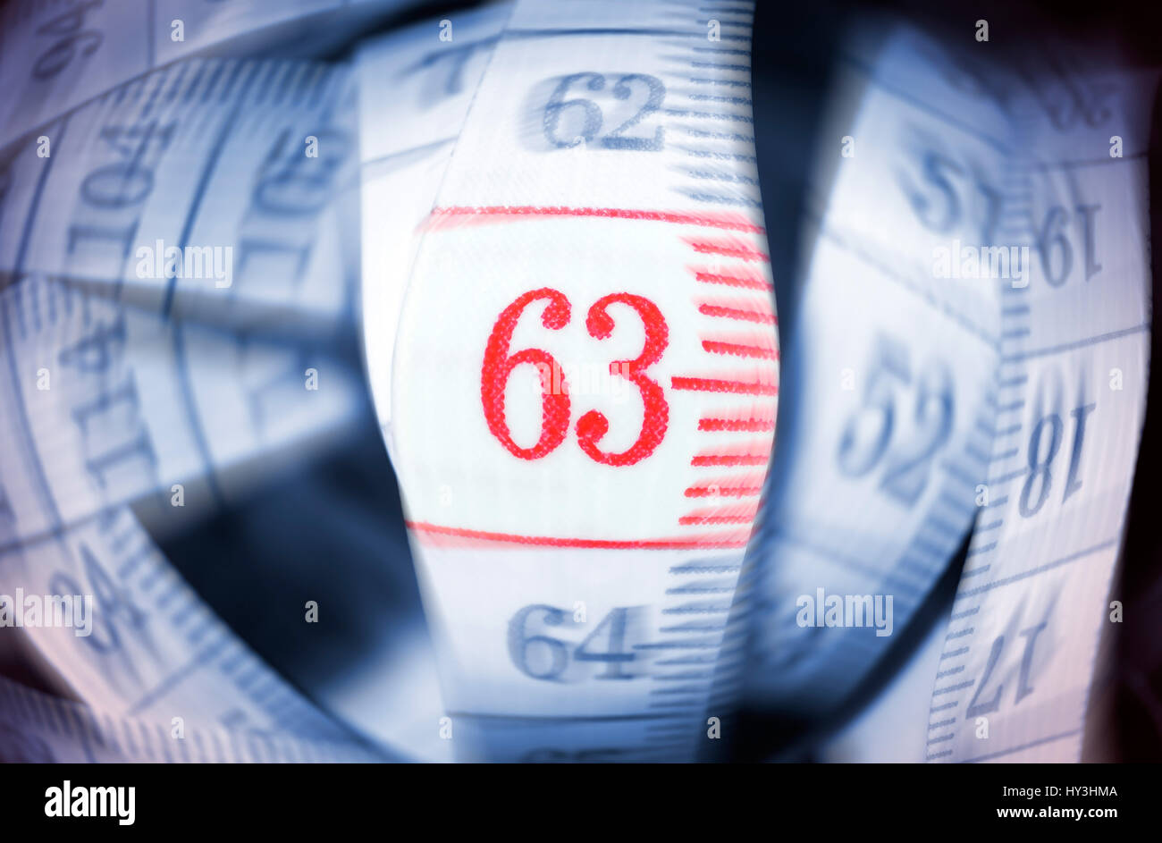 Dimension tape with the number 63, symbolic photo pension with 63, Maßband mit der Zahl 63, Symbolfoto Rente mit 63 Stock Photo