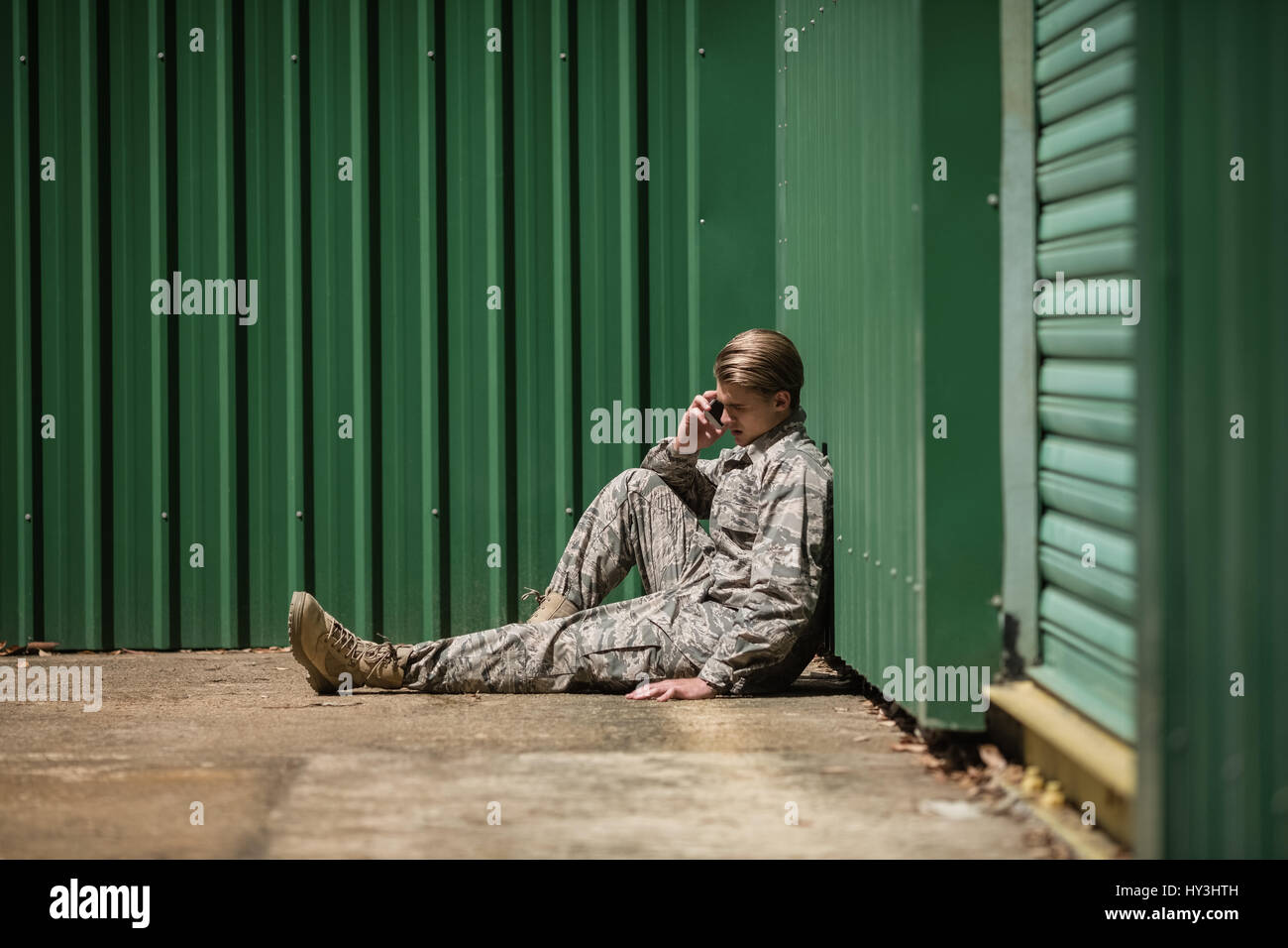 Military soldier talking on mobile phone in boot camp Stock Photo