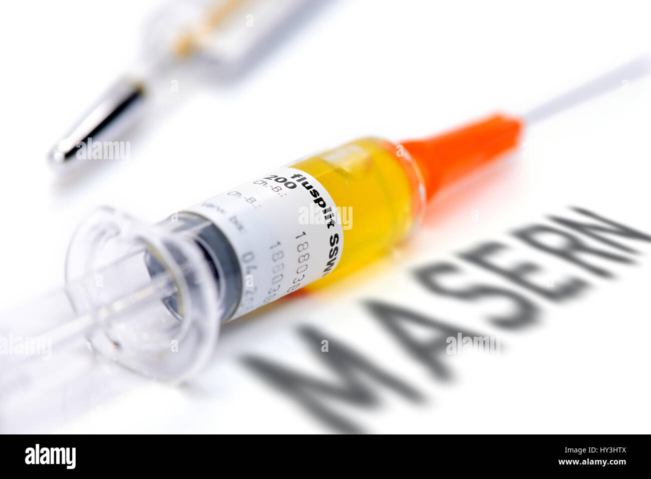 Vaccination syringe and curl stroke, vaccination against measles, Impfspritze und Masern-Schriftzug, Impfung gegen Masern Stock Photo