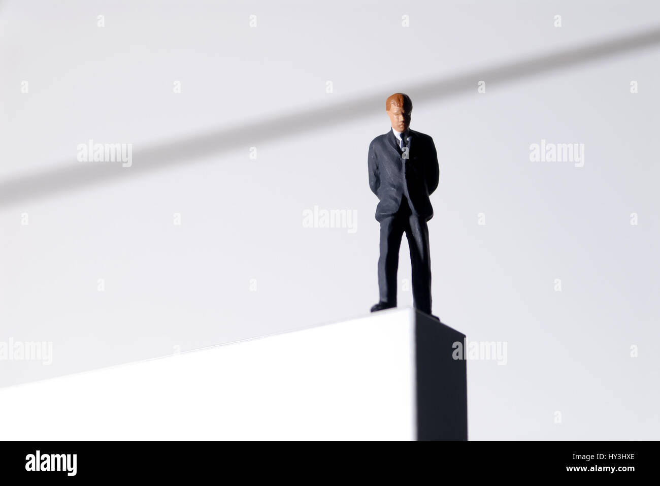Businessman in the abyss, insolvency, hopelessness, existence loss, suicide, financial bankruptcy, unemployment, social descent, miniature, horizontal Stock Photo