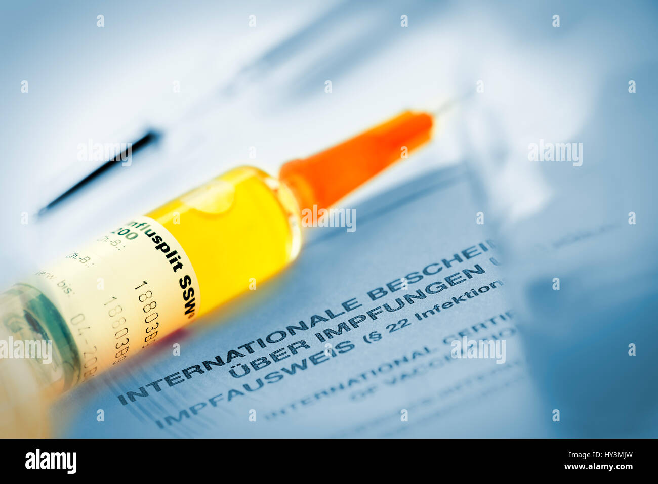 Vaccination syringe on vaccination identity card, Impfspritze auf Impfausweis Stock Photo