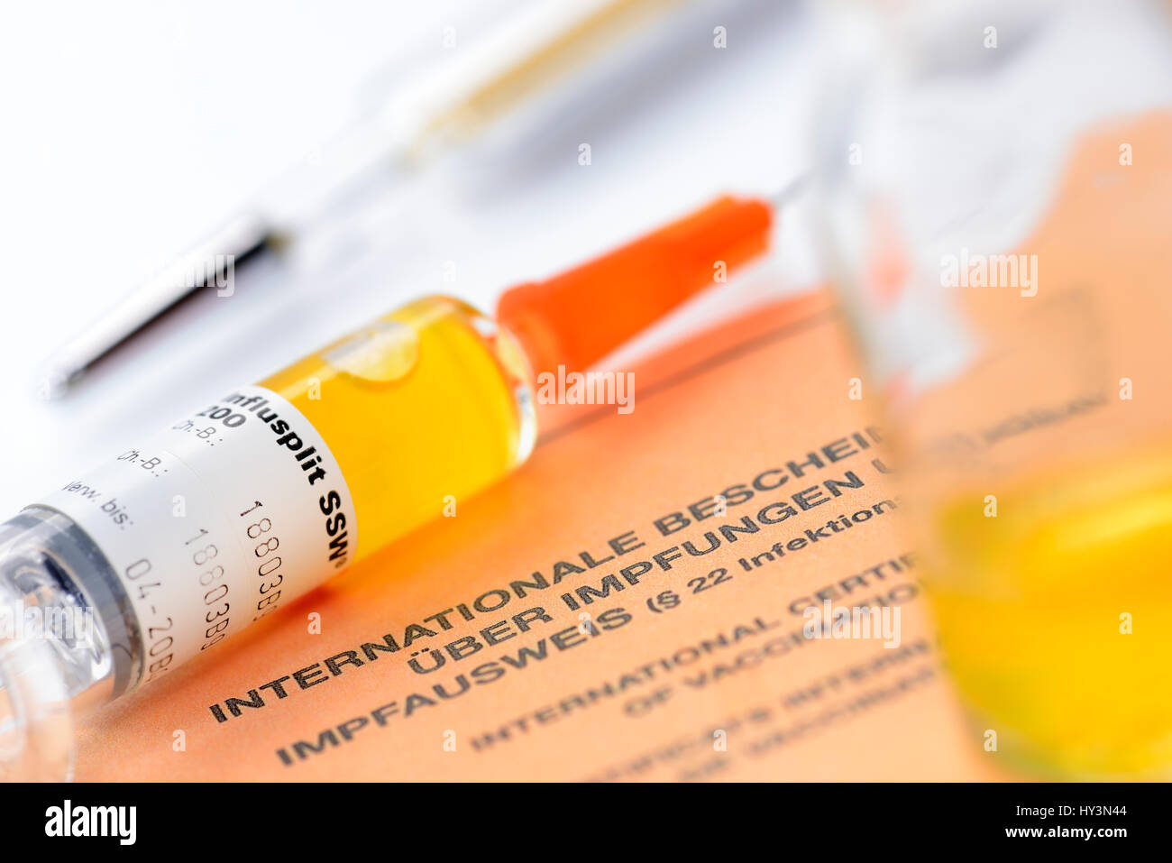 Vaccination syringe on vaccination identity card, Impfspritze auf Impfausweis Stock Photo