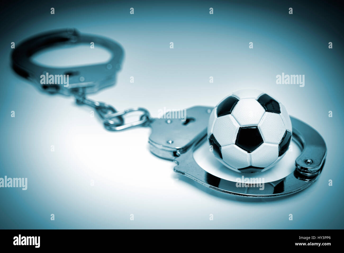 Handcuffs and miniature football, German Football Association scandal, Handschellen und Miniaturfußball, DFB-Skandal Stock Photo