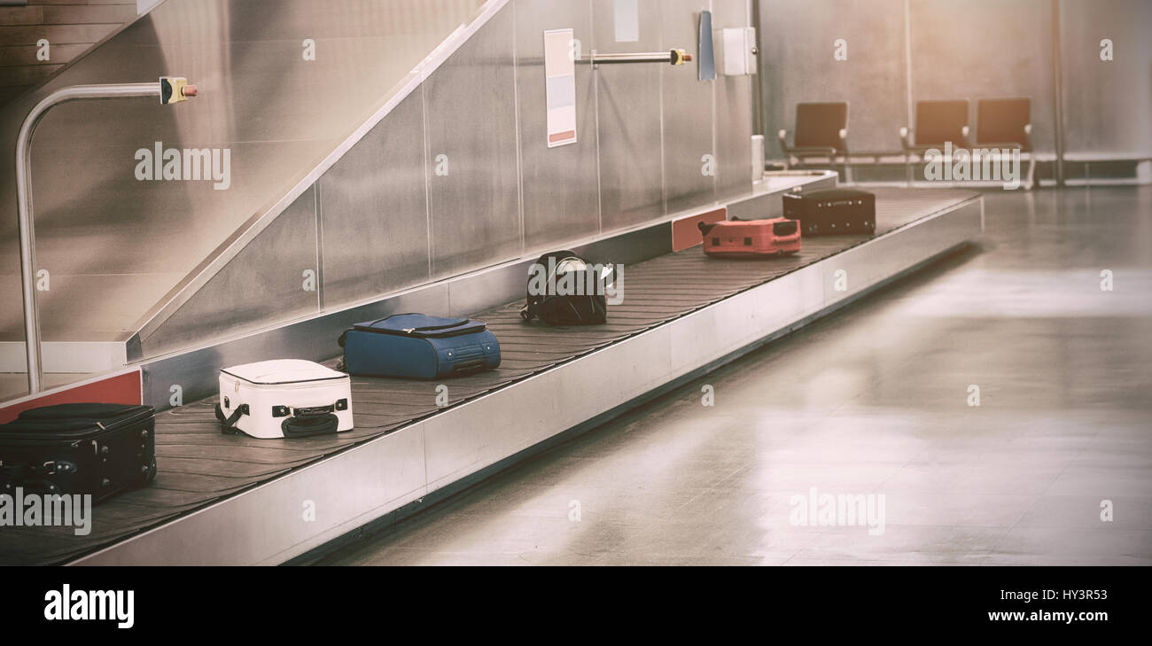 Luggage passing through baggage claim at airport Stock Photo Alamy