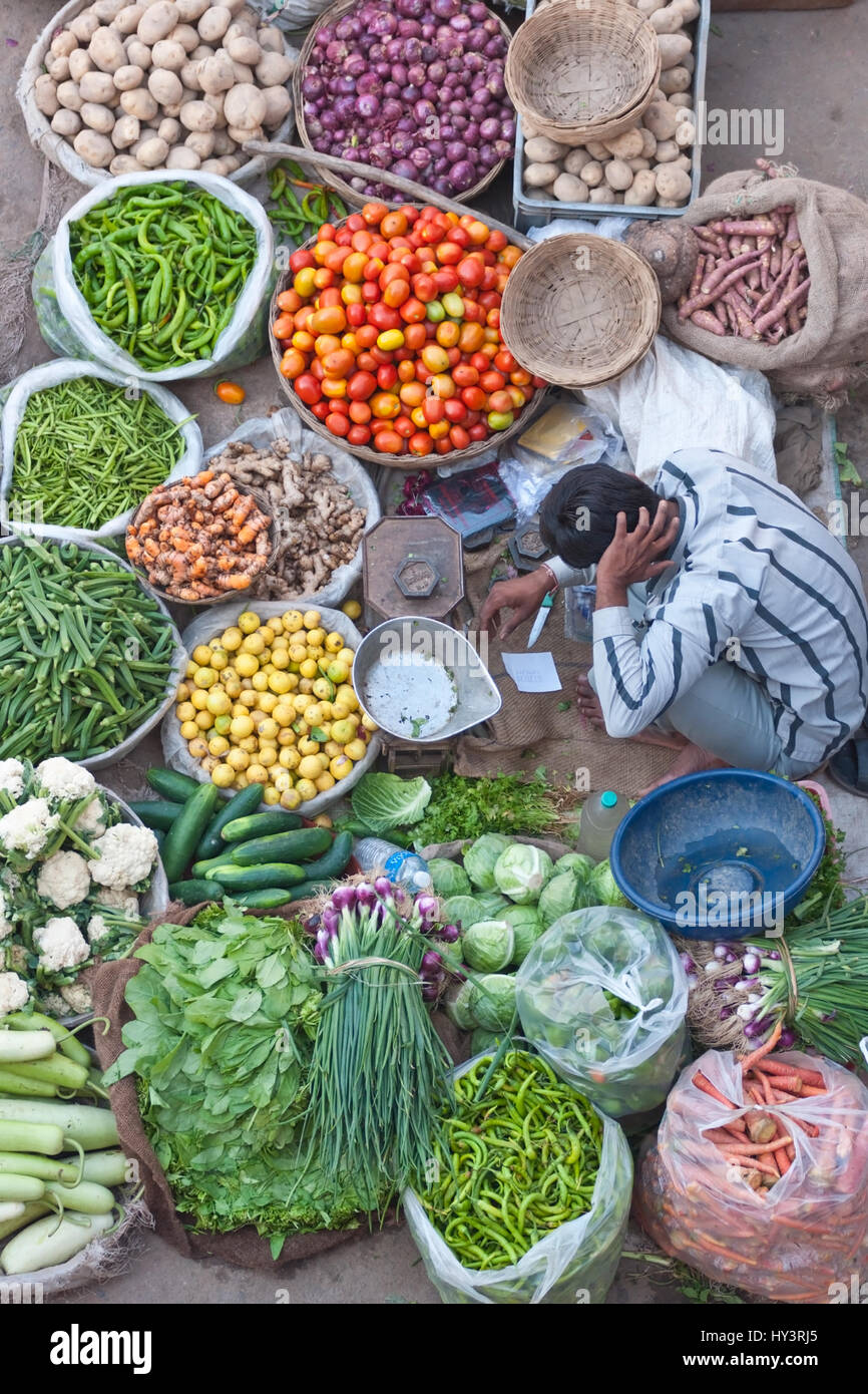 Man selling fruit and veg at a street market in Pushkar, Rajasthan
