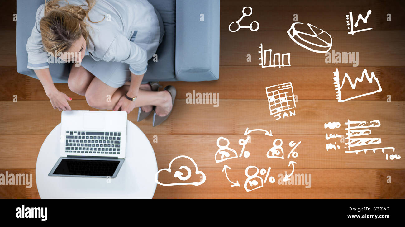 Woman on her laptop against wooden floor Stock Photo