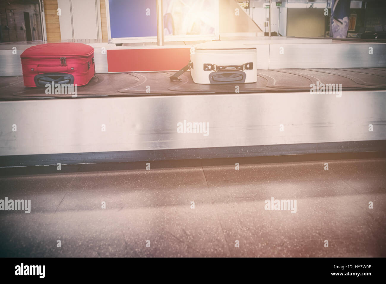Suitcase moving on baggage claim in airport Stock Photo