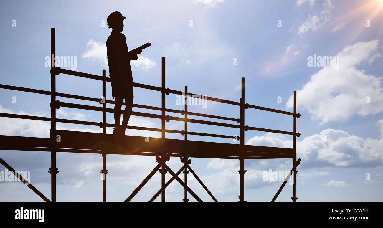 Smiling architect with hard hat against blue sky Stock Photo - Alamy