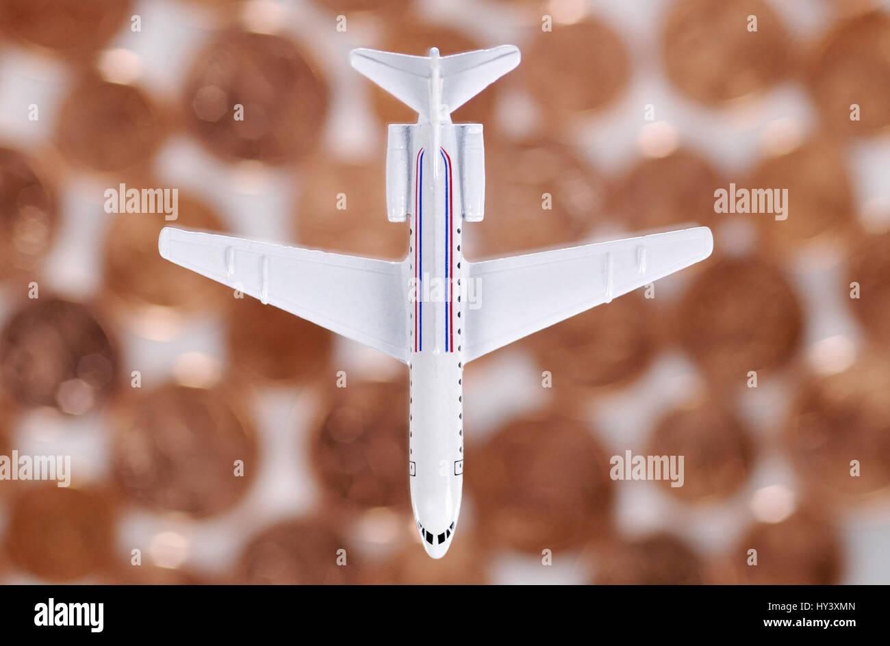 Miniature airplane about cent coins, cheap Airlines, Miniaturflugzeug ueber Cent-Muenzen, Billig-Airlines Stock Photo
