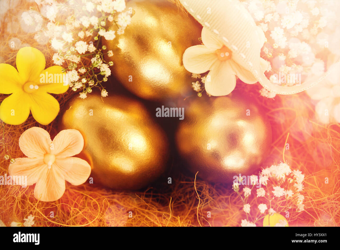 Golden easter eggs with flowers in nest against white background Stock ...