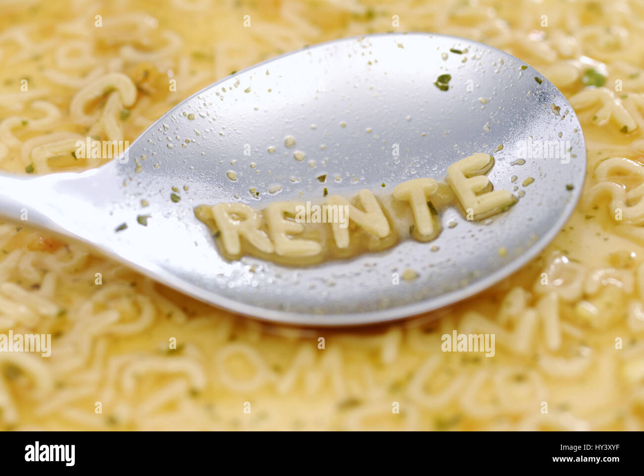 The word Pension with noodle letter on a spoon, Das Wort Rente mit Nudelbuchstaben auf einem Loeffel Stock Photo