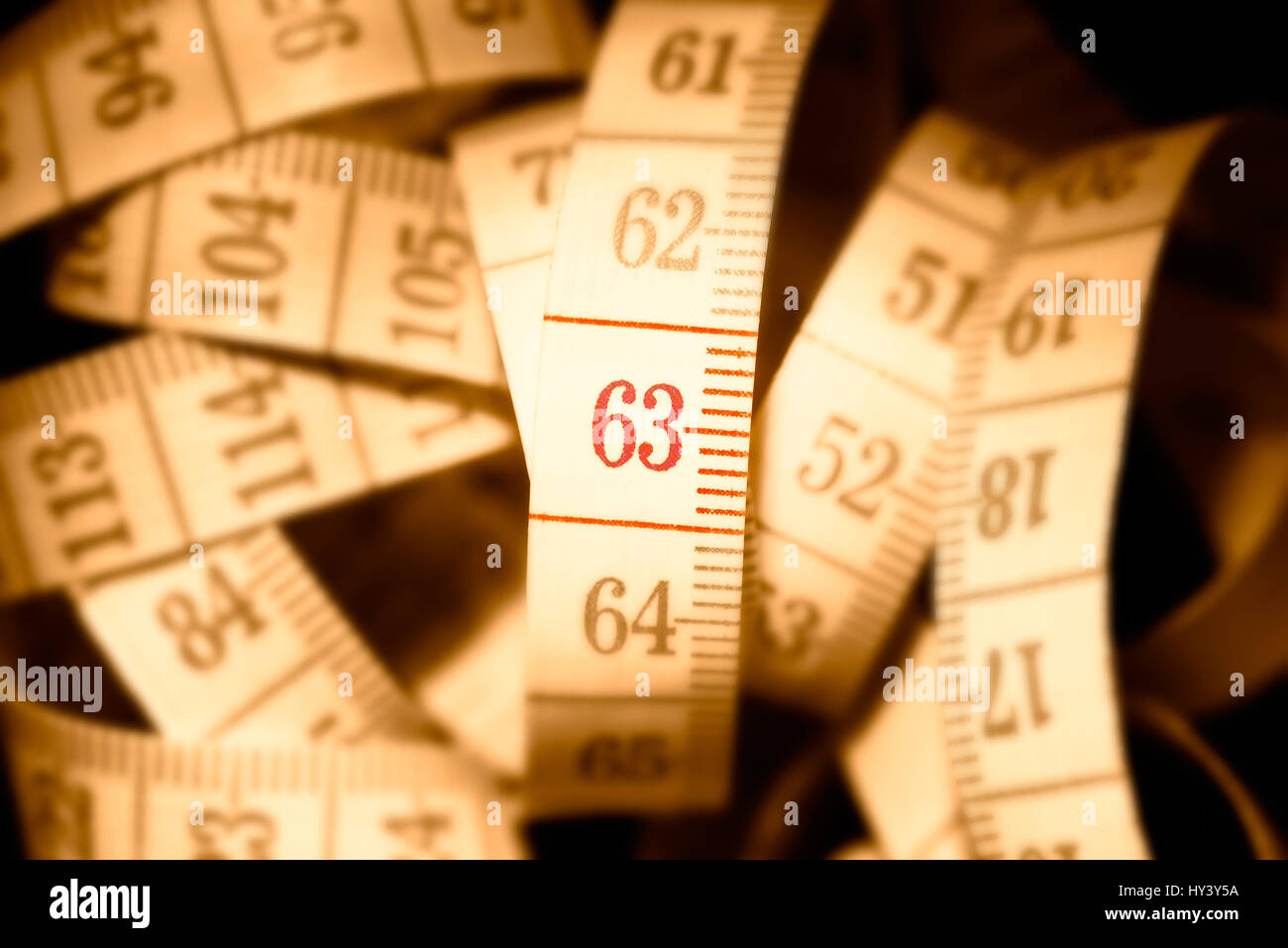 Dimension tape with the number 63, symbolic photo pension with 63, Ma?band mit der Zahl 63, Symbolfoto Rente mit 63 Stock Photo