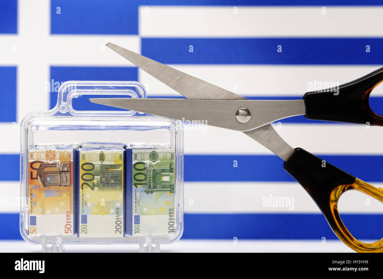 Monetary suitcase, Greece flag and scissors, debt cut for Greece, Geldkoffer, Griechenlandfahne und Schere, Schuldenschnitt fuer Griechenland Stock Photo