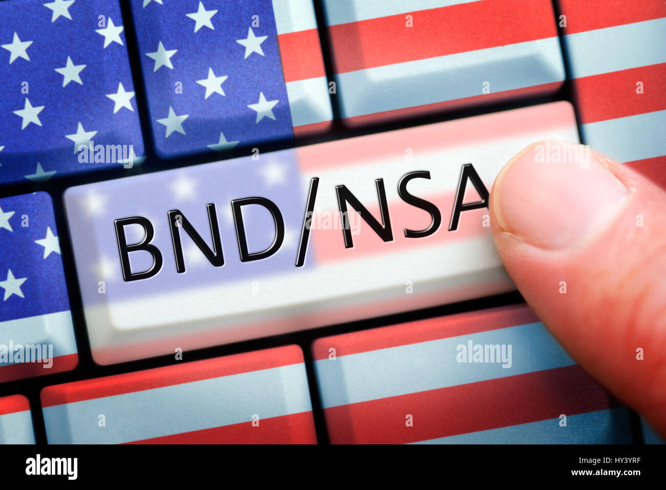 Finger on computer key with NSA and Federal Intelligence Service stroke on USA-national colours, symbolic photo Federal Intelligence Service scandal,  Stock Photo