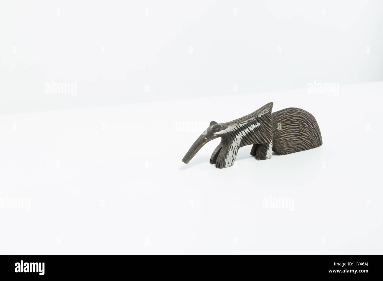 Anteater, black and white carved on wood isolated in white background Stock Photo