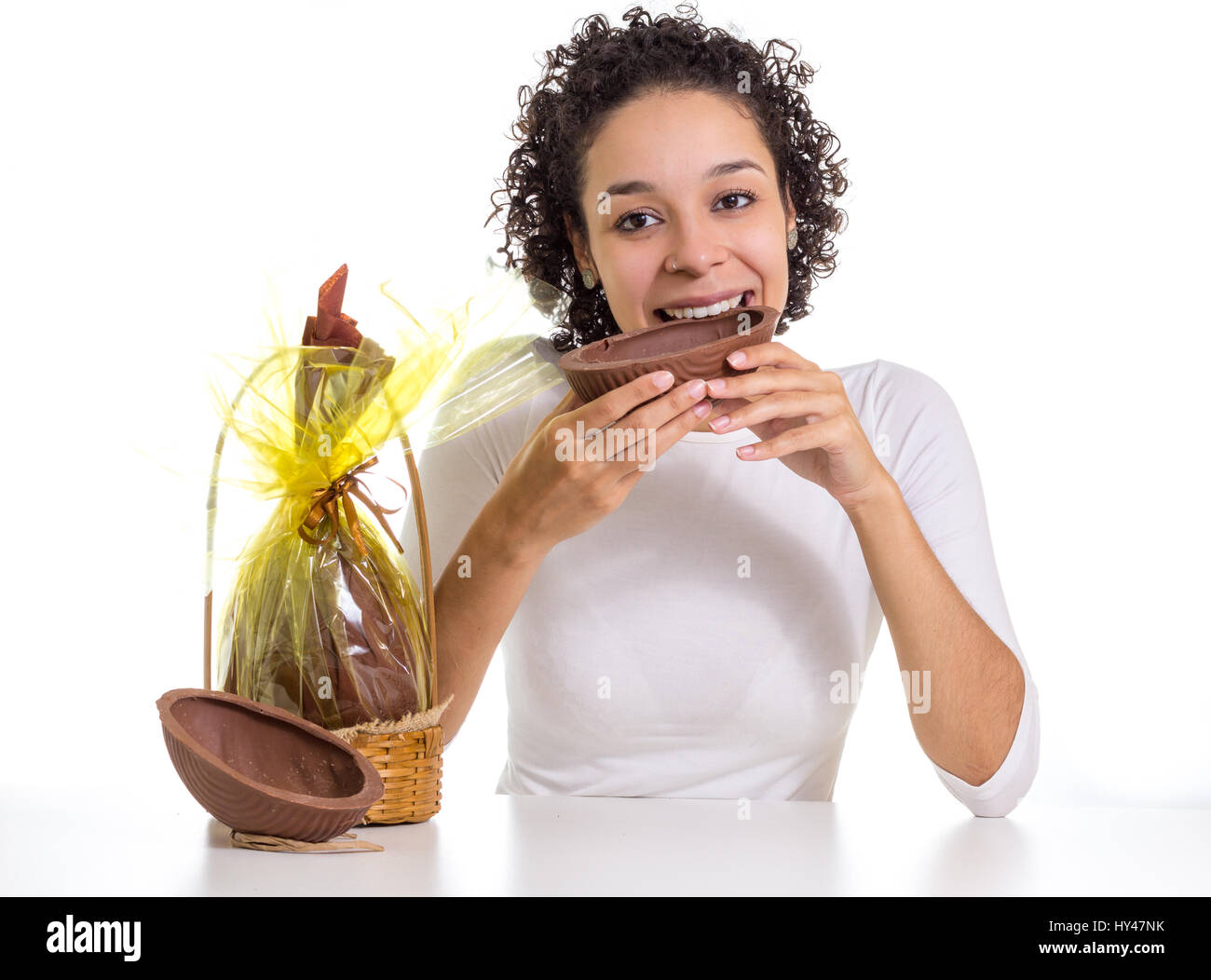 Young Girl With Short Hair Tastes A Delicious Chocolate Egg At