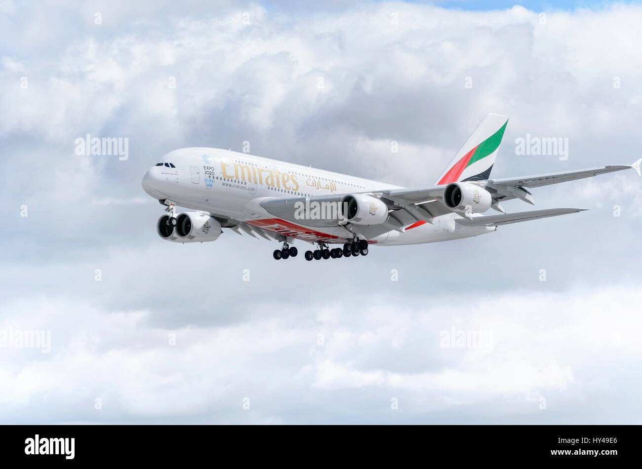 Plane Airbus A380, of Emirates airline, is landing in Madrid - Barajas, Adolfo Suarez airport. It's the world's largest passenger airliner. Clouds. Stock Photo