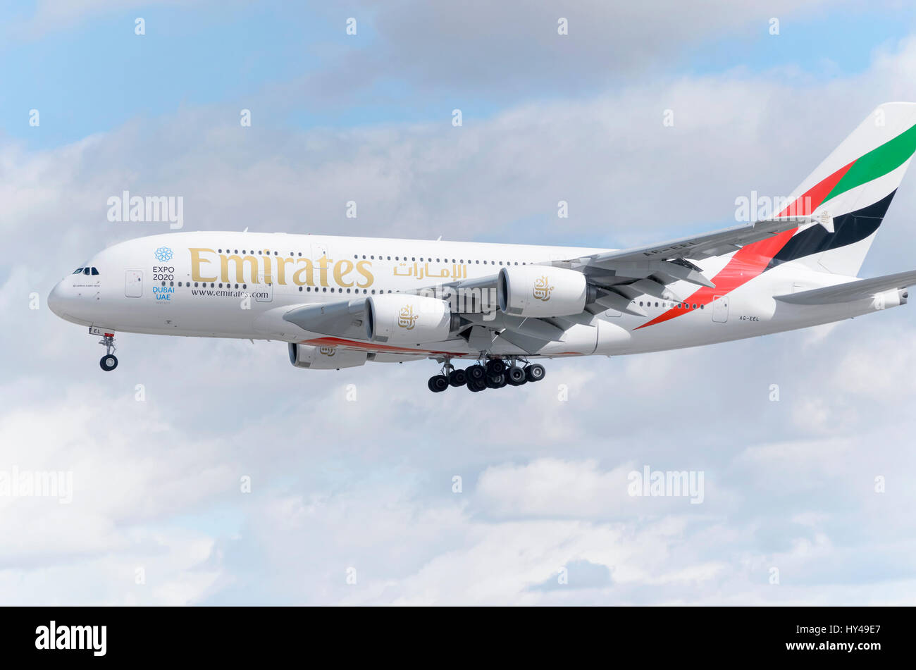 Plane Airbus A380, of Emirates airline, is landing in Madrid - Barajas, Adolfo Suarez airport. It's the world's largest passenger airliner. Clouds. Stock Photo