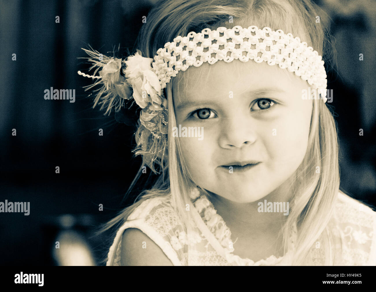 Close up of a sweet little toddler girl wearing an old fashioned headband Stock Photo