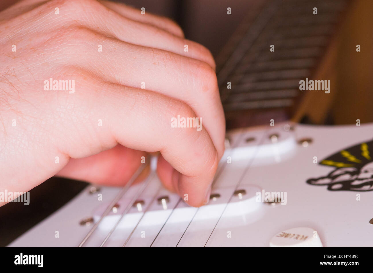 Hand strumming a guitar Stock Photo Alamy