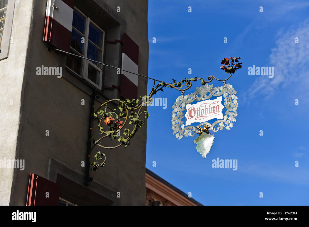 An advertising hanging sign of Ottoburg restaurant on the outside wall of the building, Innsbruck, Austria Stock Photo