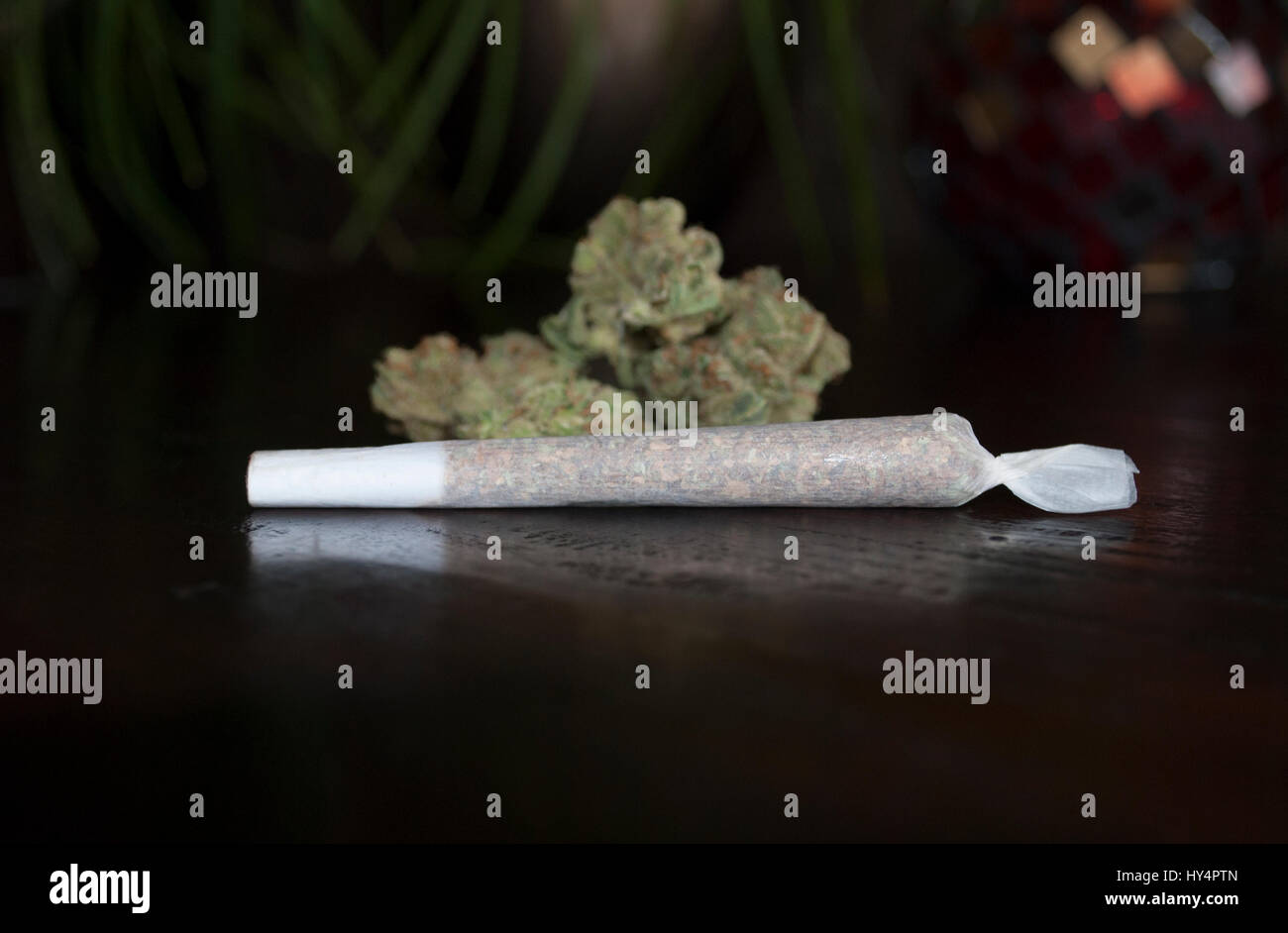 closeup of rolled marijuana weed joint on wooden background Stock Photo