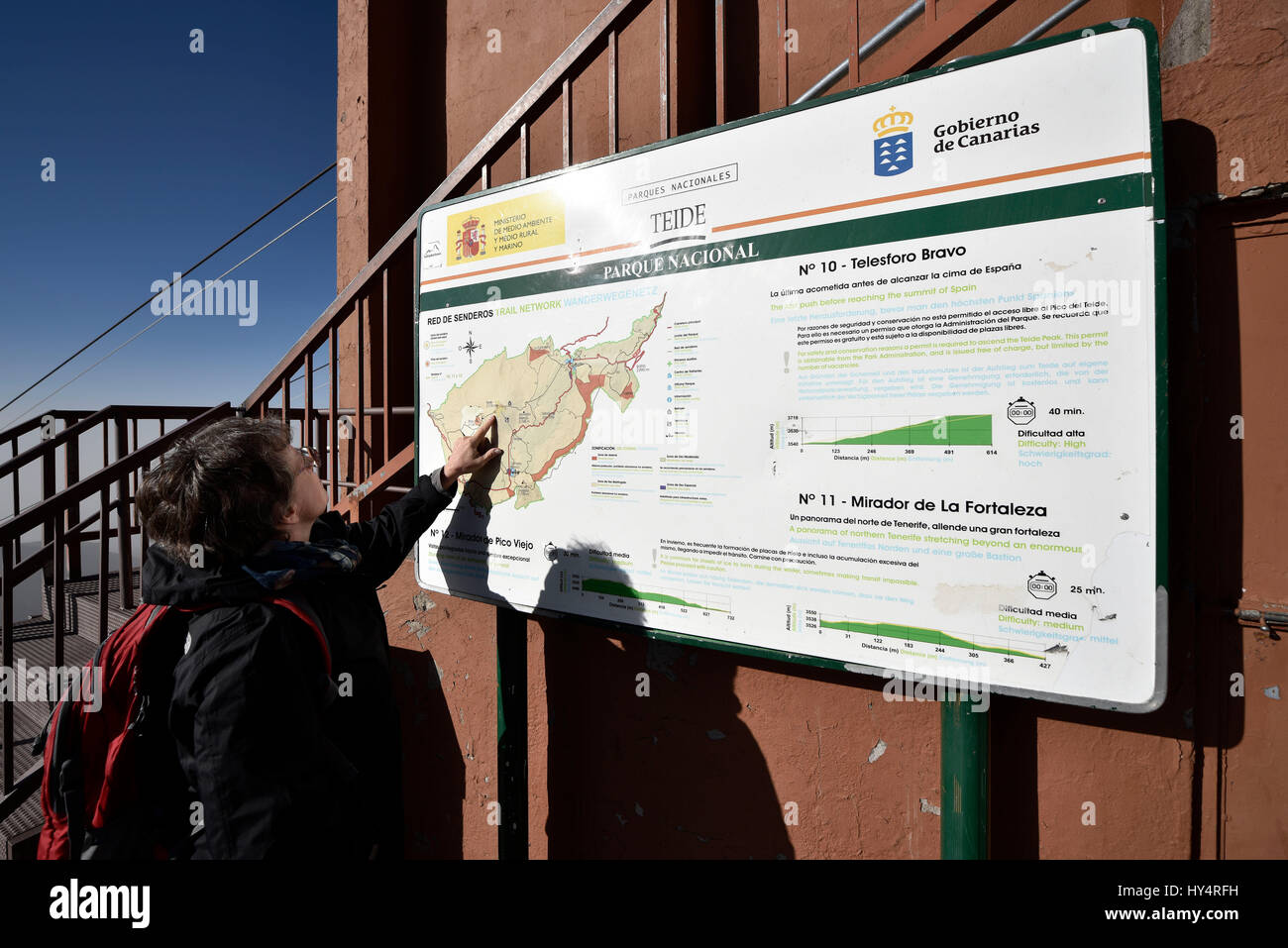 Woman in front of information panel, hiking trails, mountain station of cable car Teleferico del Teide, Pico del Teide, Teide National Park, Tenerife, Canary Islands, Spain Stock Photo