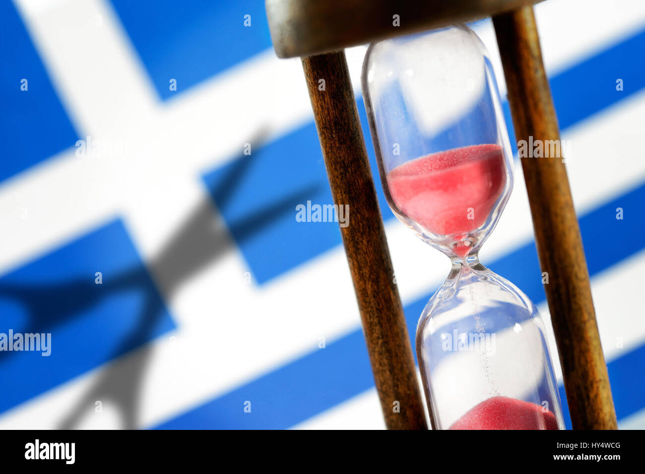 Greek flag, hourglass and shade of scissors, symbolic photo Greek debt cut, Griechische Fahne, Sanduhr und Schatten einer Schere, Symbolfoto griechisc Stock Photo
