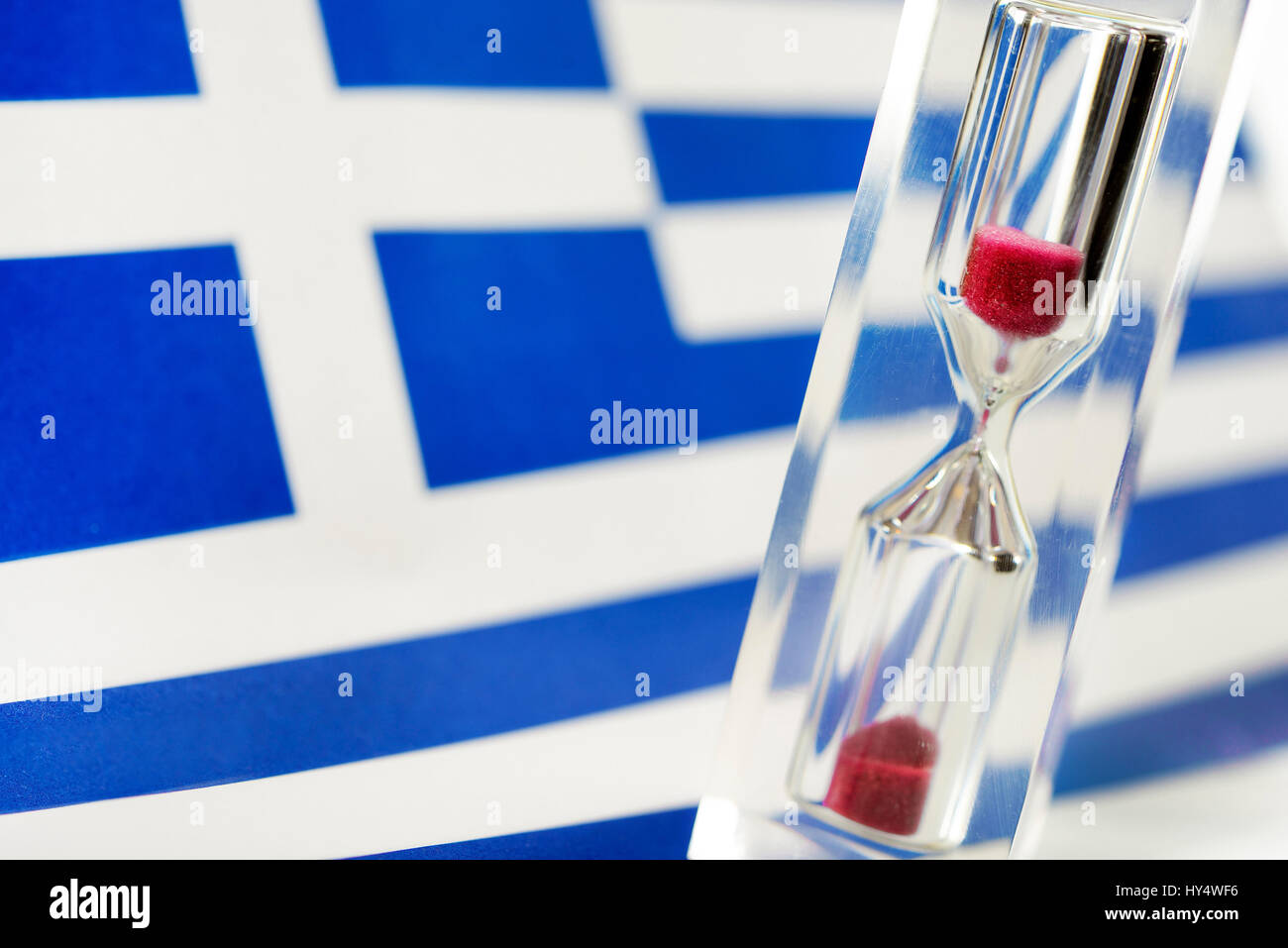 Greek flag and hourglass, symbolic photo Greek debt crisis, Griechische Fahne und Sanduhr, Symbolfoto griechische Schuldenkrise Stock Photo
