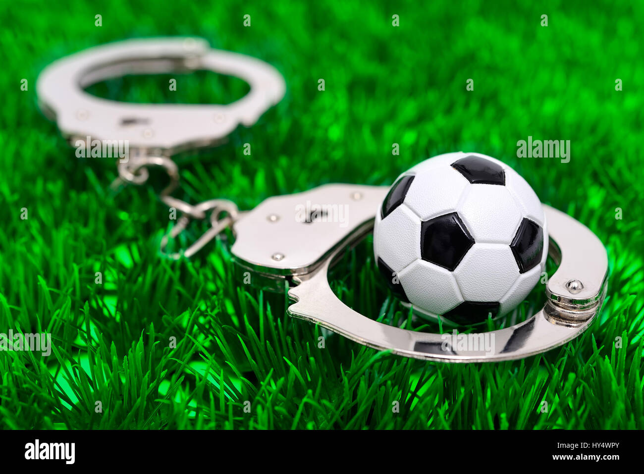 Handcuffs and miniature football, German Football Association scandal, Handschellen und Miniaturfu?ball, DFB-Skandal Stock Photo
