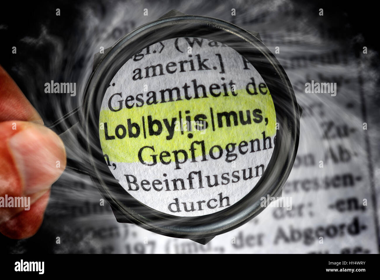 The word Lobbyism in a dictionary under the magnifying glass, Das Wort Lobbyismus in einem Woerterbuch unter der Lupe Stock Photo