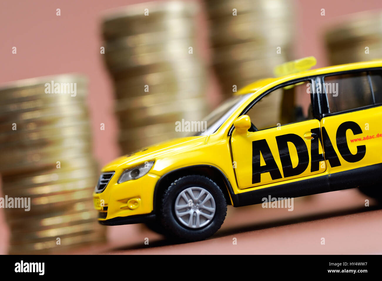 ADAC miniature vehicle and coin pile, ADAC Miniaturfahrzeug und Muenzstapel Stock Photo