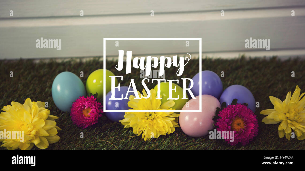 Easter greeting against multicolored easter egg on grass Stock Photo