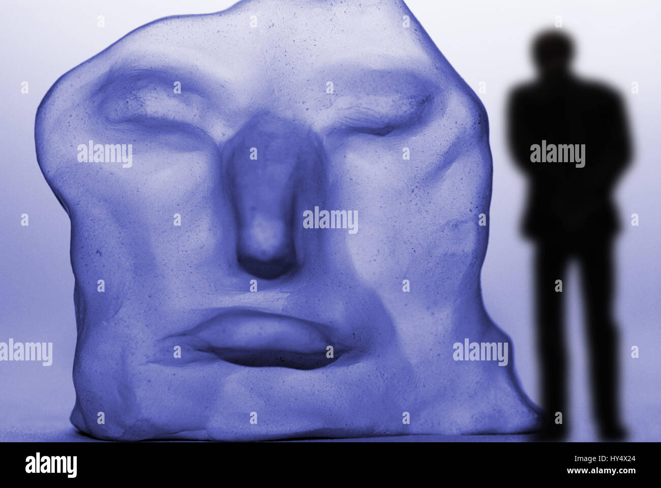 Lonesome man before a distorted face, depression, Einsamer Mann vor einem verzerrten Gesicht, Depression Stock Photo