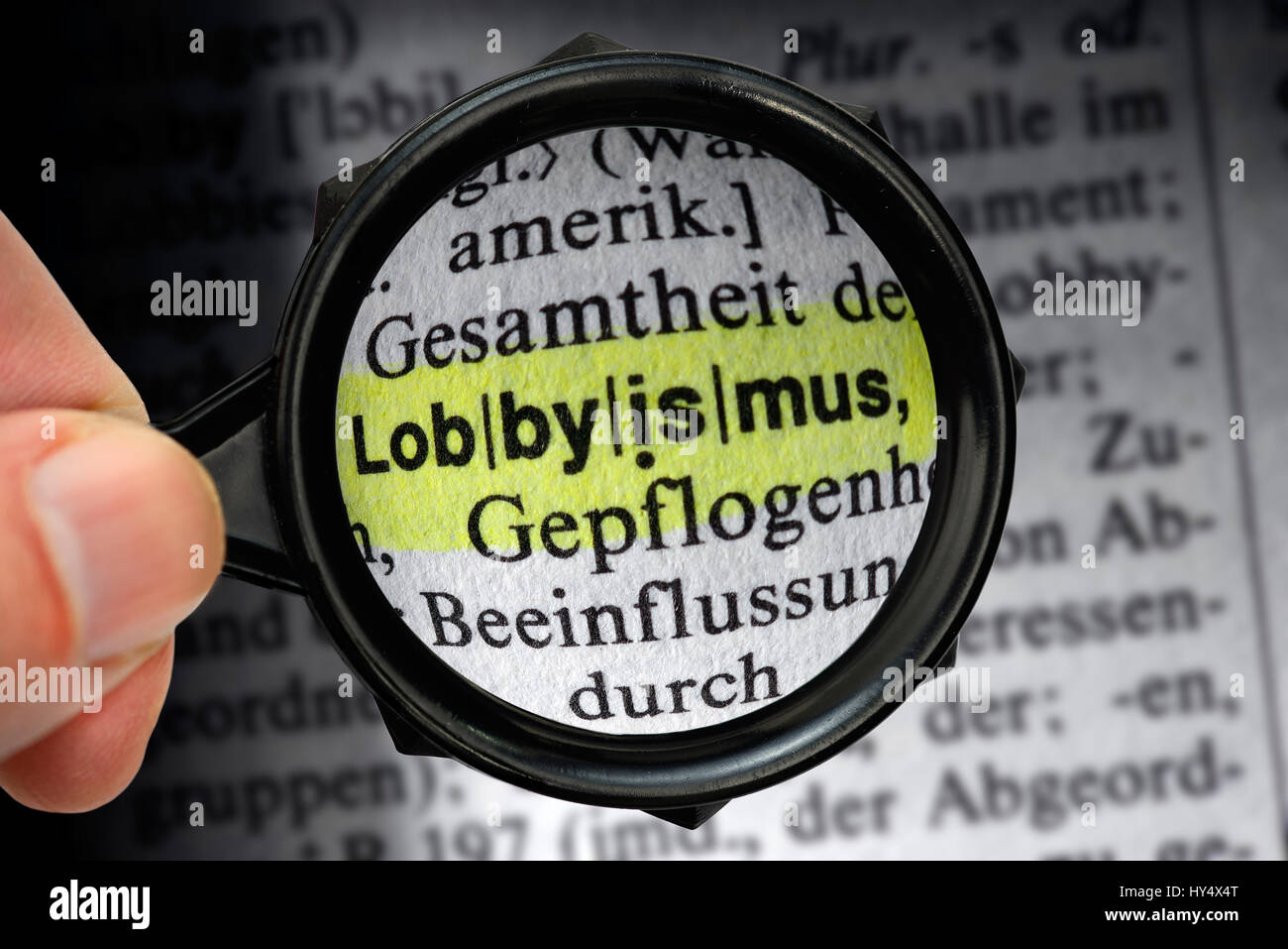 The word Lobbyism in a dictionary under the magnifying glass, Das Wort Lobbyismus in einem Woerterbuch unter der Lupe Stock Photo