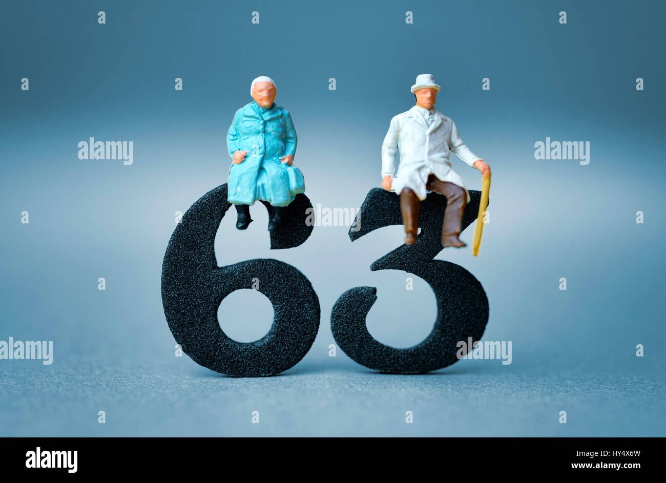 Senior citizen's pair on the number 63, symbolic photo pension at the age of 63 years, Seniorenpaar auf der Zahl 63, Symbolfoto Rente mit 63 Jahren Stock Photo