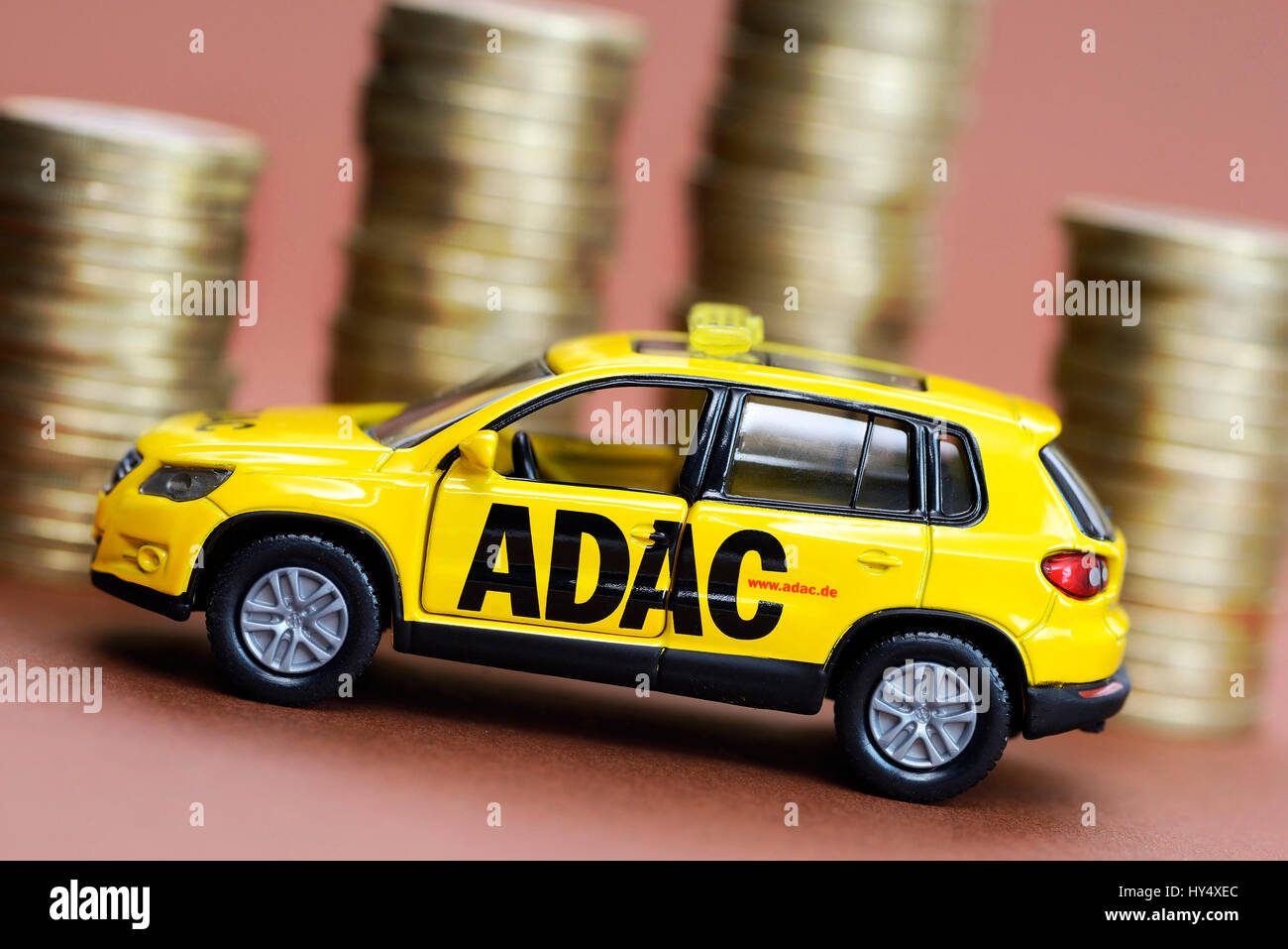 ADAC miniature vehicle and coin pile, ADAC Miniaturfahrzeug und Muenzstapel Stock Photo