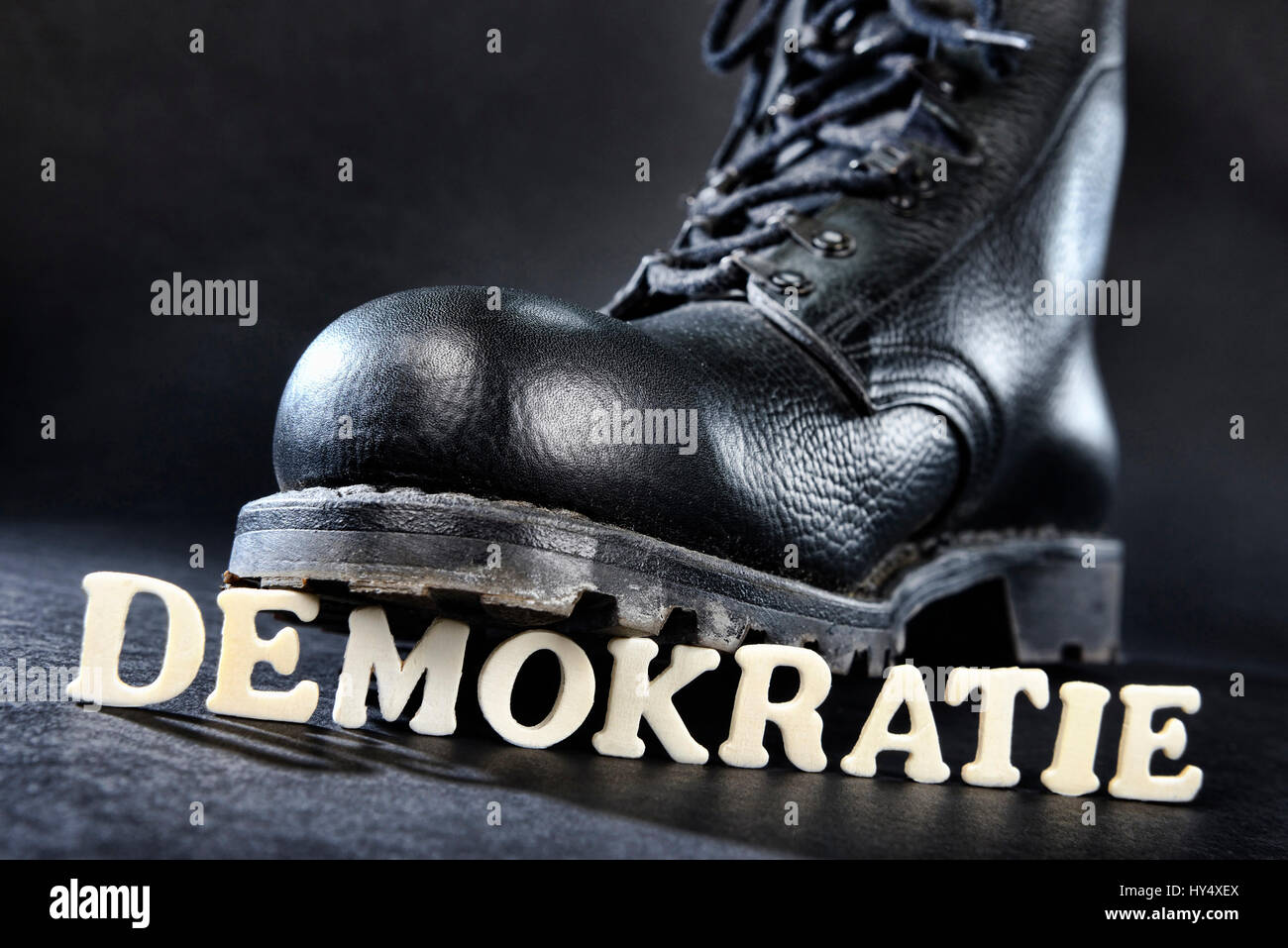 Jumper's boot on democracy stroke, right-wing extremism, Springerstiefel auf Demokratie-Schriftzug, Rechtsextremismus Stock Photo