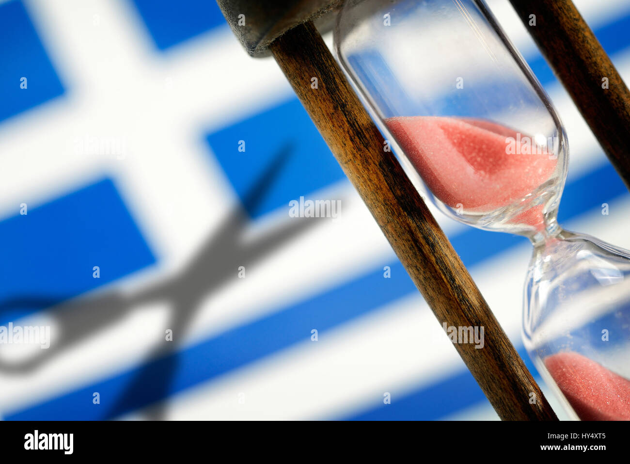 Greek flag, hourglass and shade of scissors, symbolic photo Greek debt cut, Griechische Fahne, Sanduhr und Schatten einer Schere, Symbolfoto griechisc Stock Photo