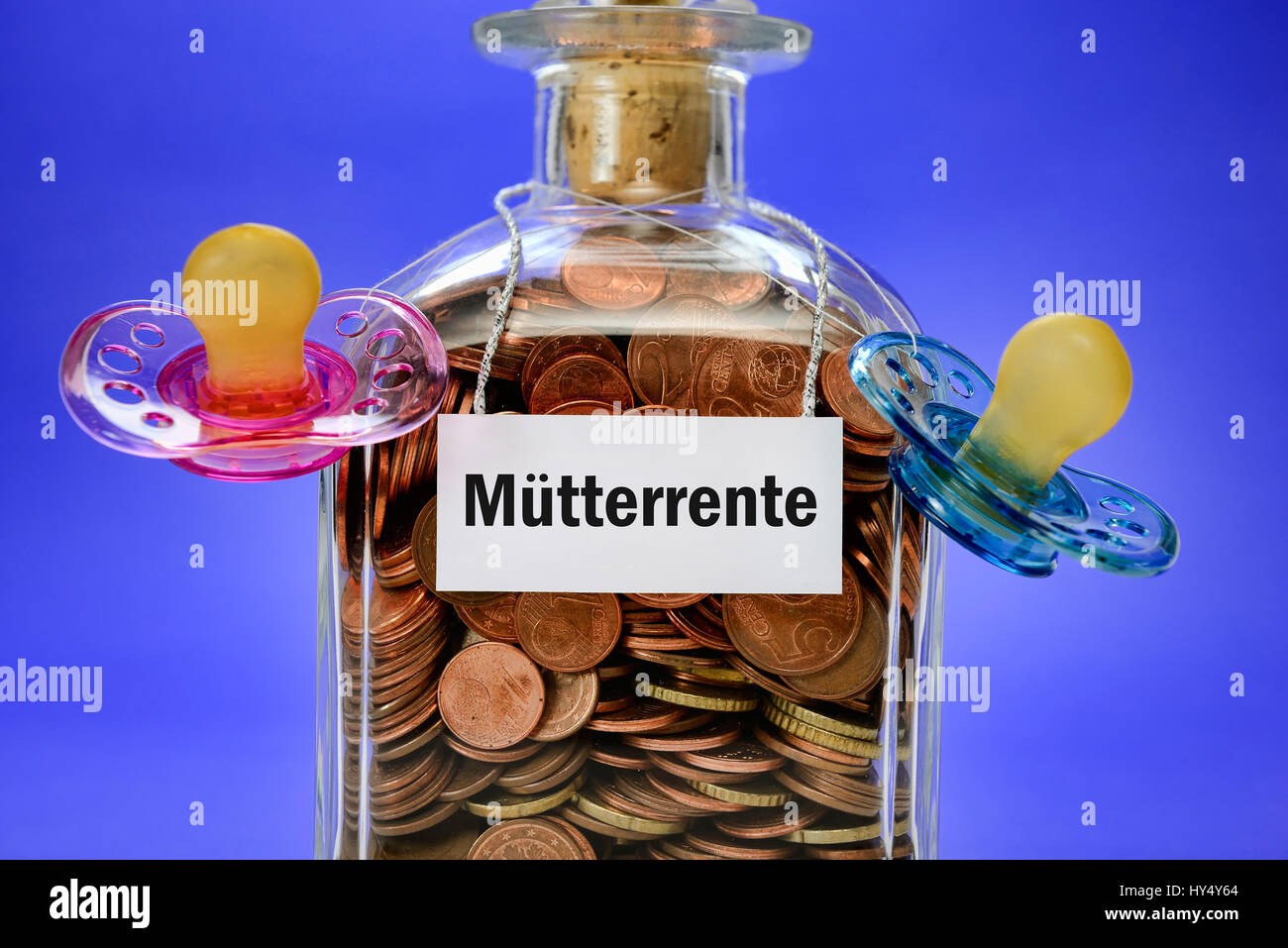 Bottle with monetary coins and dummies, symbolic photo mother's pension, Flasche mit Geldmuenzen und Schnullern, Symbolfoto Muetterrente Stock Photo