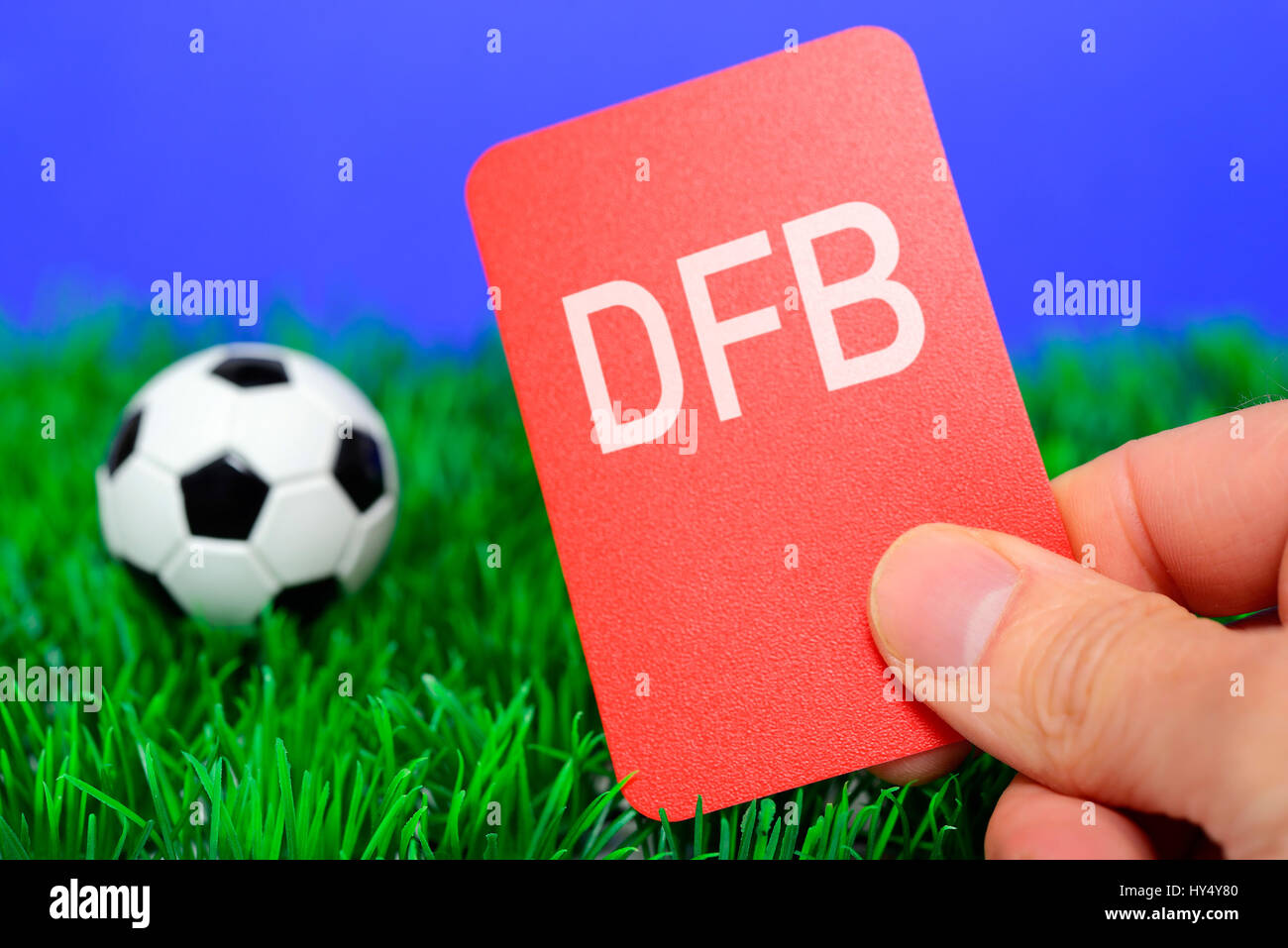 Miniature football and hand with red map, German Football Association scandal, Miniaturfu?ball und Hand mit roter Karte, DFB-Skandal Stock Photo