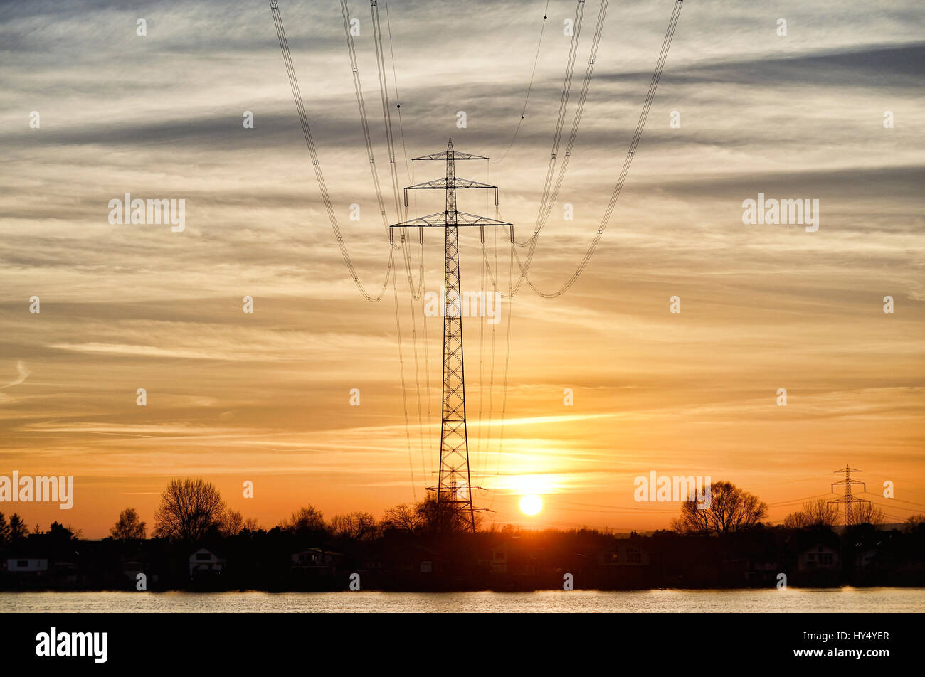 High-tension mast at sundown in Hamburg, Germany, Europe, Hochspannungsmast bei Sonnenuntergang in Hamburg, Deutschland, Europa Stock Photo