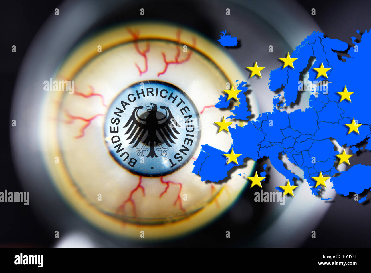 Eye with Federal Intelligence Service sign under the magnifying glass and European map, Ausspaehung of EU countries, Auge mit BND-Zeichen unter der Lu Stock Photo