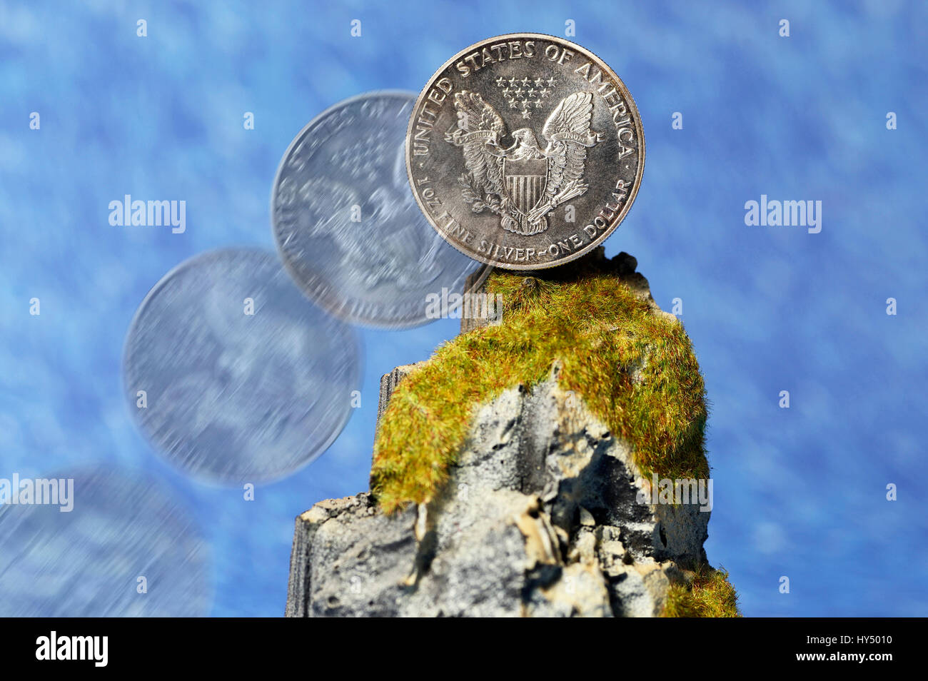 US-silver dollar on cliff, tax inspector's cliff, US-Silberdollar auf Klippe, Fiskalklippe Stock Photo