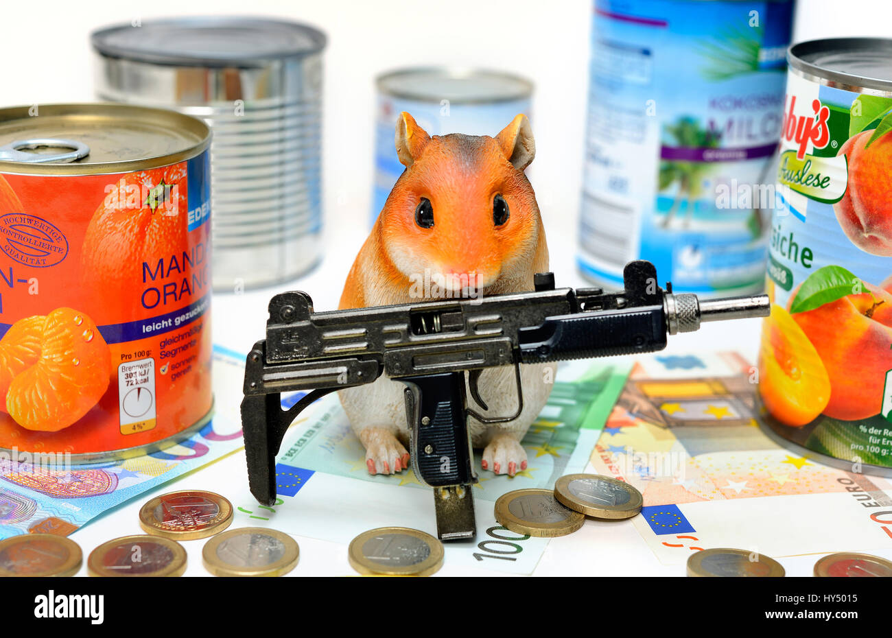 Hamster's figure with canned food tins and machine gun, symbolic photo hamster's purchases, Hamsterfigur mit Konservendosen und Maschinengewehr, Symbo Stock Photo